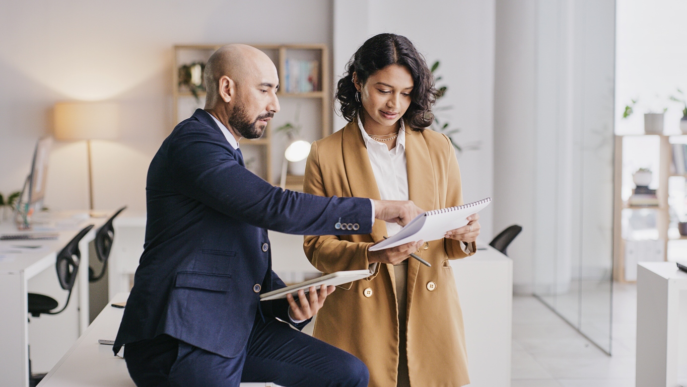 "Business Valuation Expert consulting with a client in office setting.