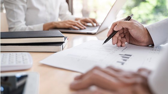 Two business teamwork calculating a valuation in workplace.