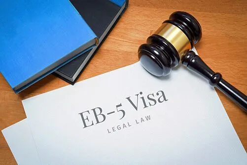 EB-5 citizenship by investment documentation with gavel and legal book